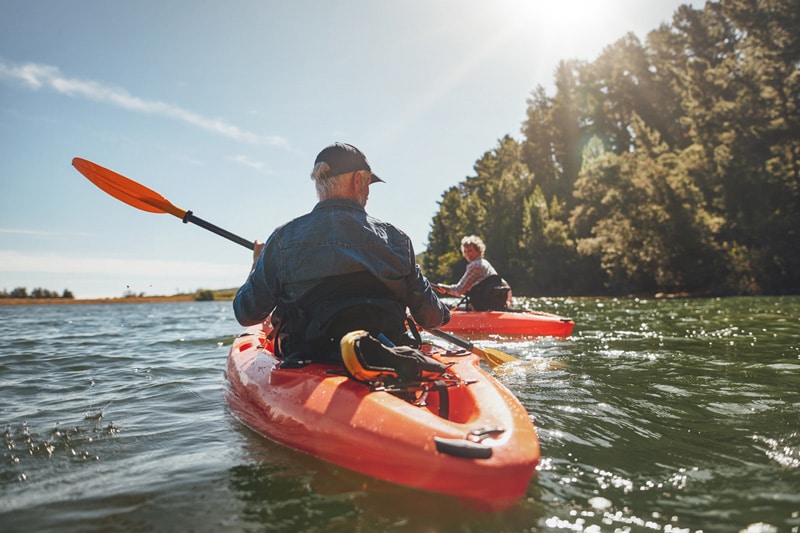 A couple paddling down a river