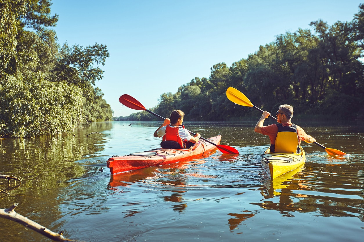 Two men kayaking down a river