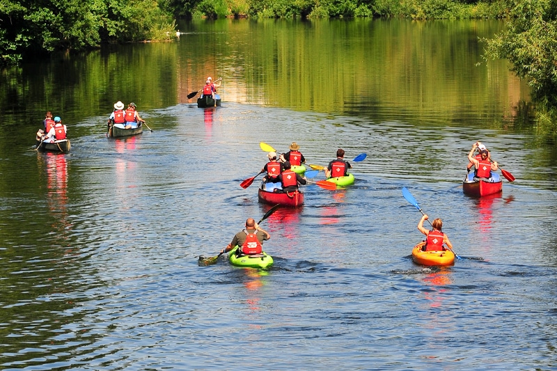a group of men kayaking in the water