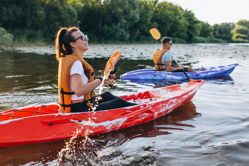 A couple kayaking together in a river