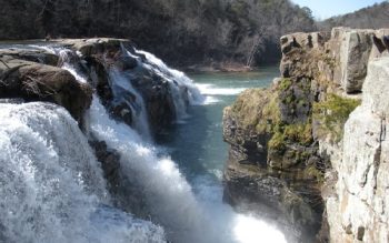 Large Waterfalls Flowing Into A River