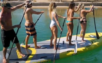 A Group Of People That Are Standing In The Water
