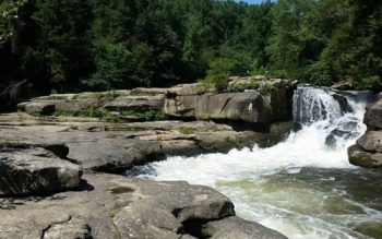 A Large Waterfall And A Pool Of Water