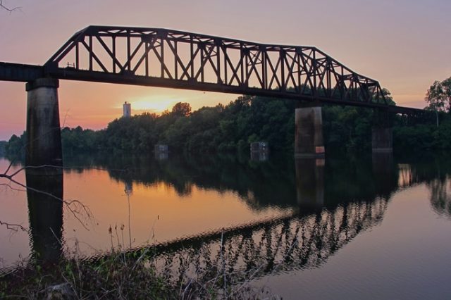 A Train Crossing A Bridge Over A Body Of Water
