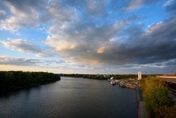 A View Overlooking The Alabama River And Montgomery Riverwalk Complete With Riverboat And Amphitheater.