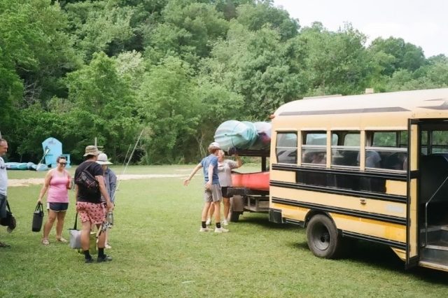 A Group Of Kayakers Loading A Bus