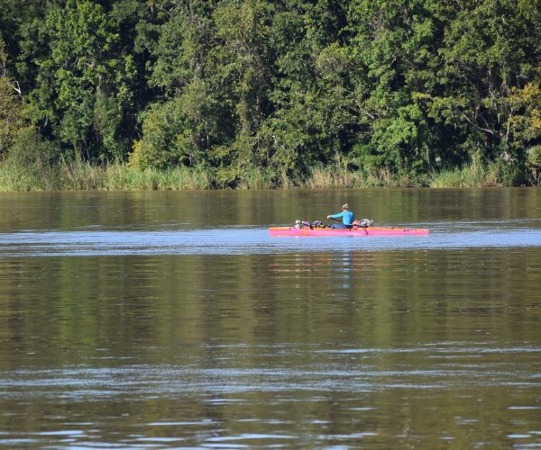 A Woman Kayaking Down A River