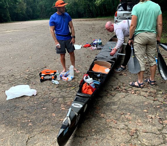 People Unloading A Row Boat