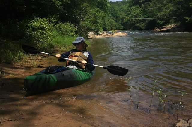 Kayaker Pulling Up To Shore