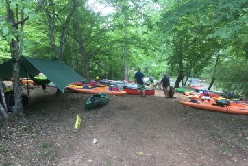 Kayakers Setting Up Camp Near A River