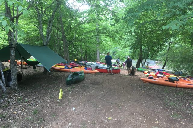 Kayakers Setting Up Camp Near A River