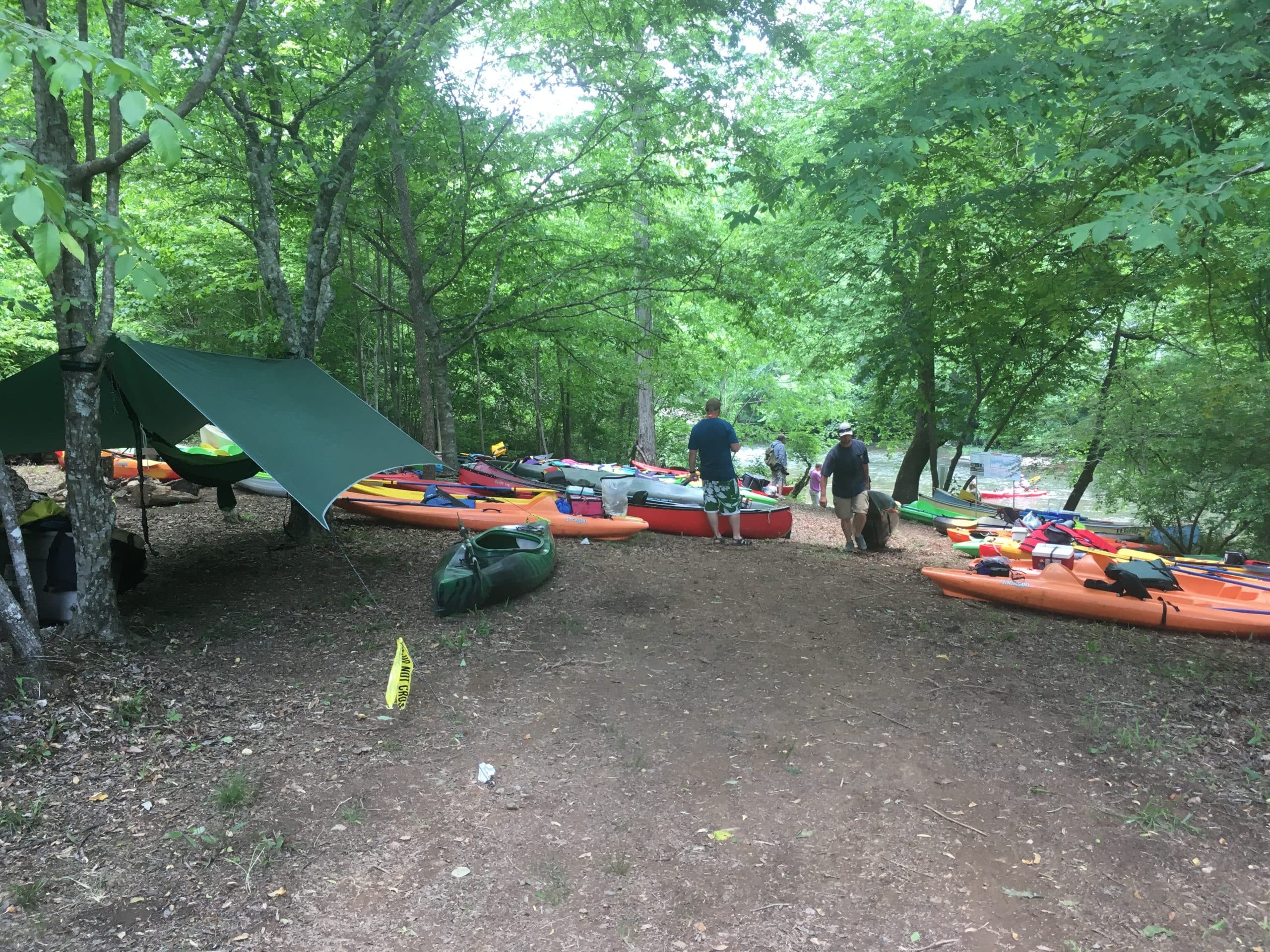 Kayakers setting up camp near a river