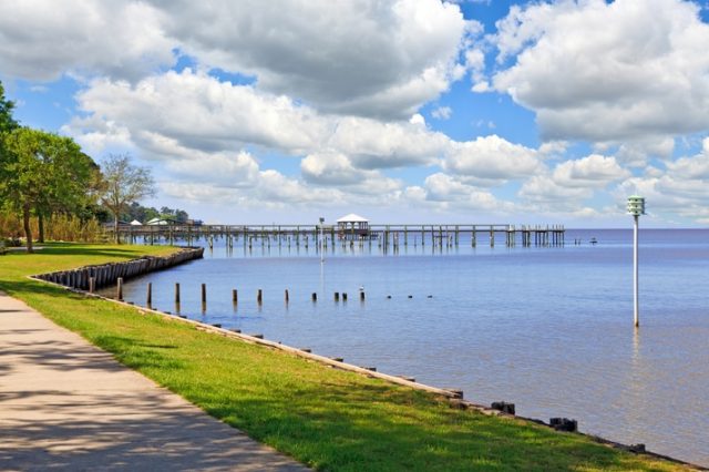 A View Of A Pier Next To A Body Of Water