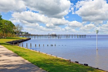 A View Of A Pier Next To A Body Of Water