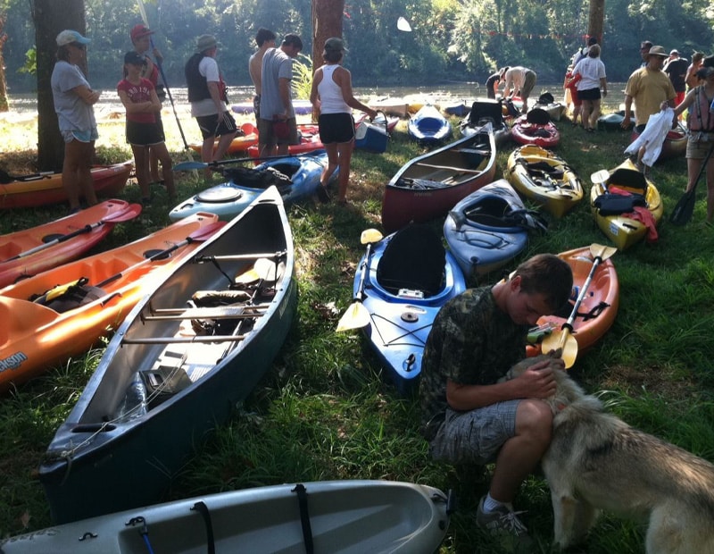 Kayakers resting next to a river