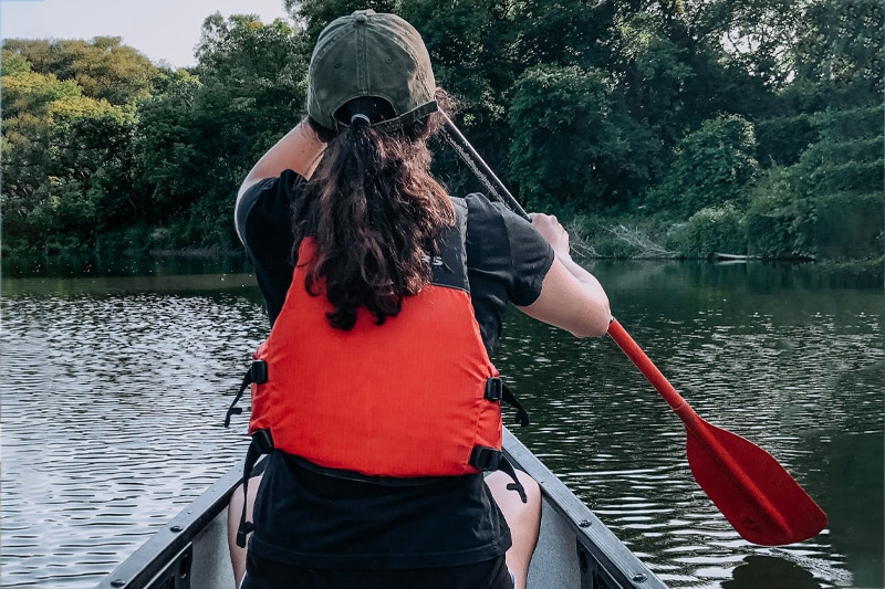 A woman steering a canoe