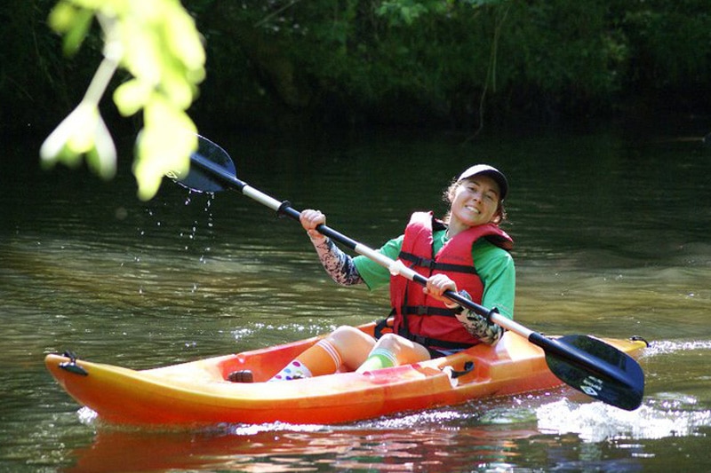 A woman kayaking on a river