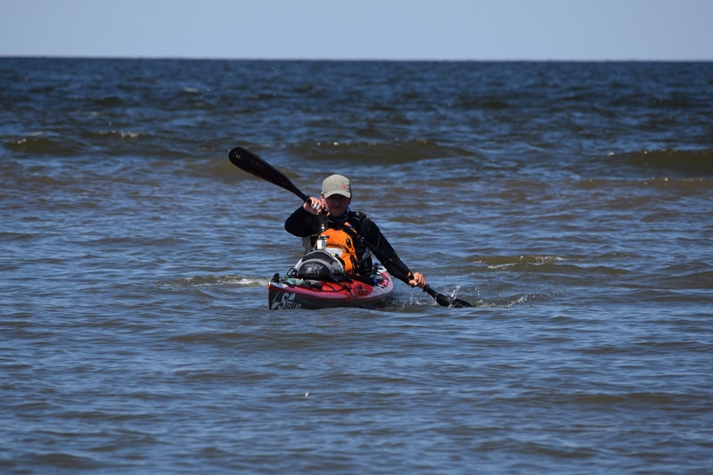 a man riding kayaking in the ocean