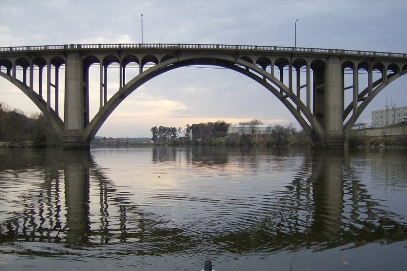 a train crossing a bridge over a body of water