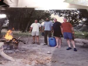 a group of people standing around a fire