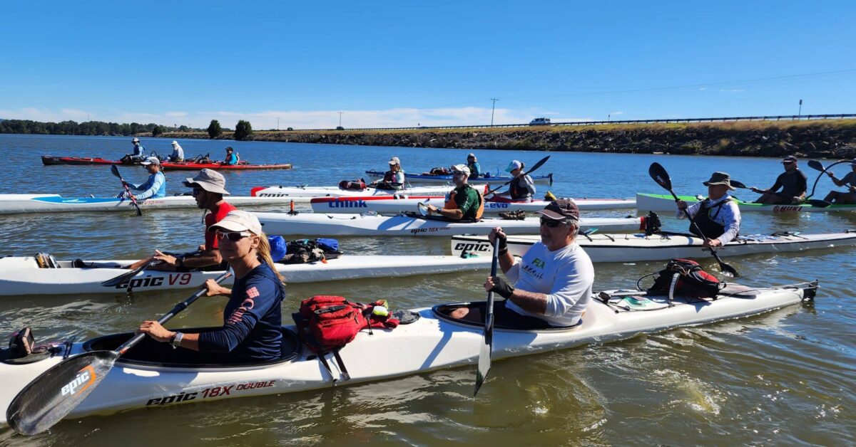 A Group Of People Rowing Boats In A