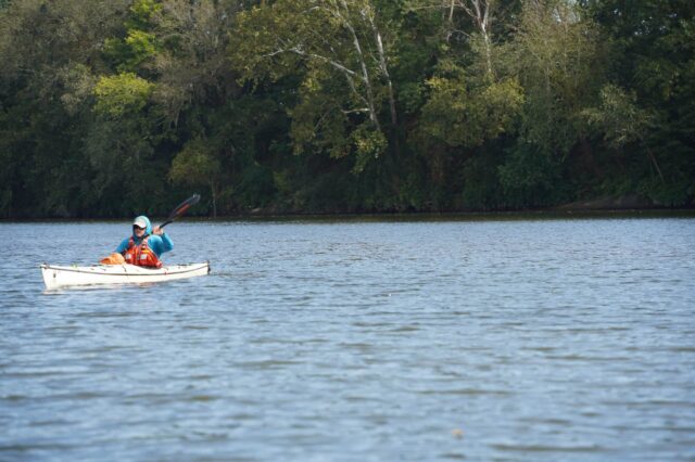 A Man Kayaking In A River