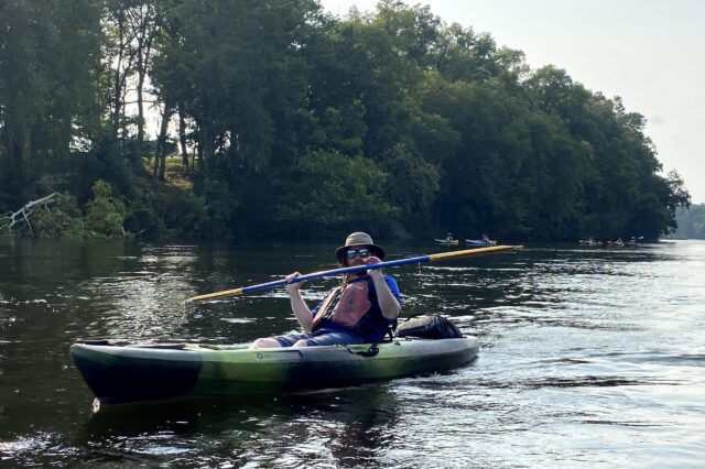 A Man Kayaking Down A River