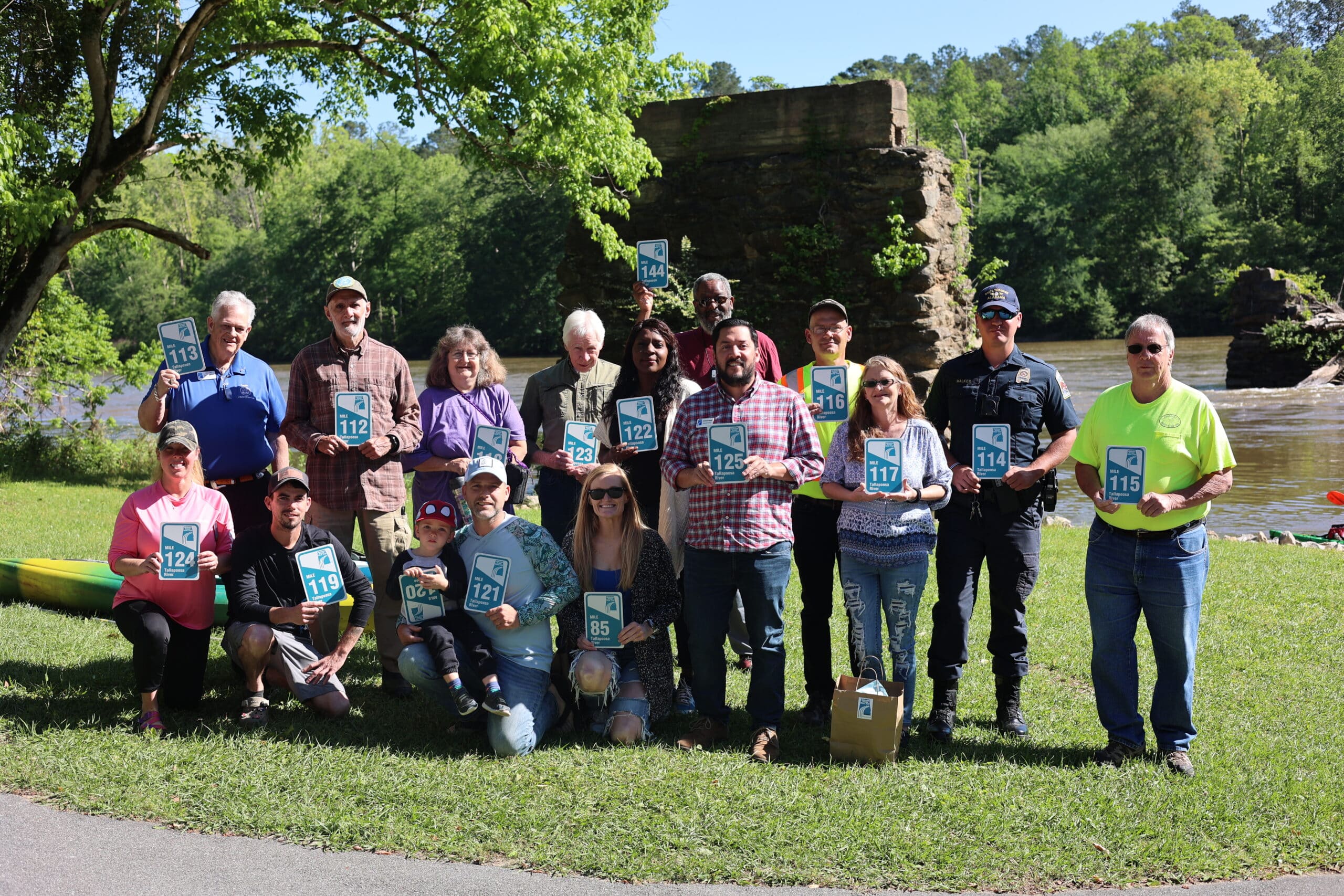 Volunteers standing with mile markers