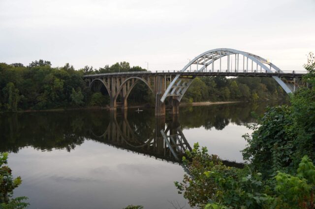 Kayaker Under A Bridge