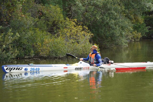 A Man Kayaking Down A River