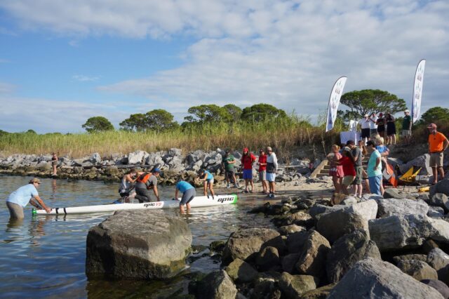 A Group Of People Welcoming An Alabama 650 Kayaker