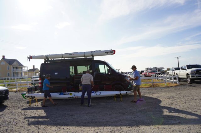Men Loading Their Kayaks On A Van