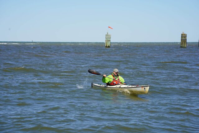 Man Kayaking In The Ocean Off Of Alabama's Coastline