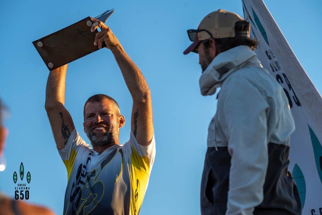a man carrying a surfboard