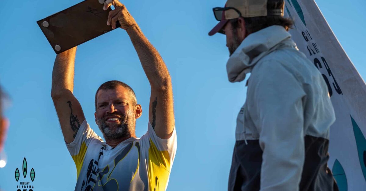 a man carrying a surfboard