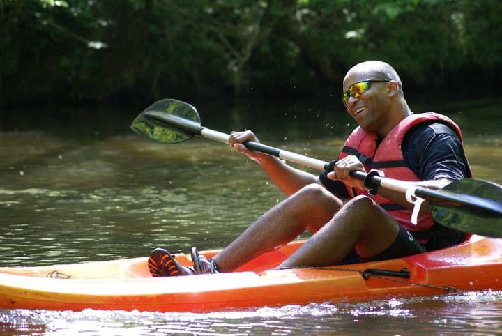 a person riding on the back of a boat in the water