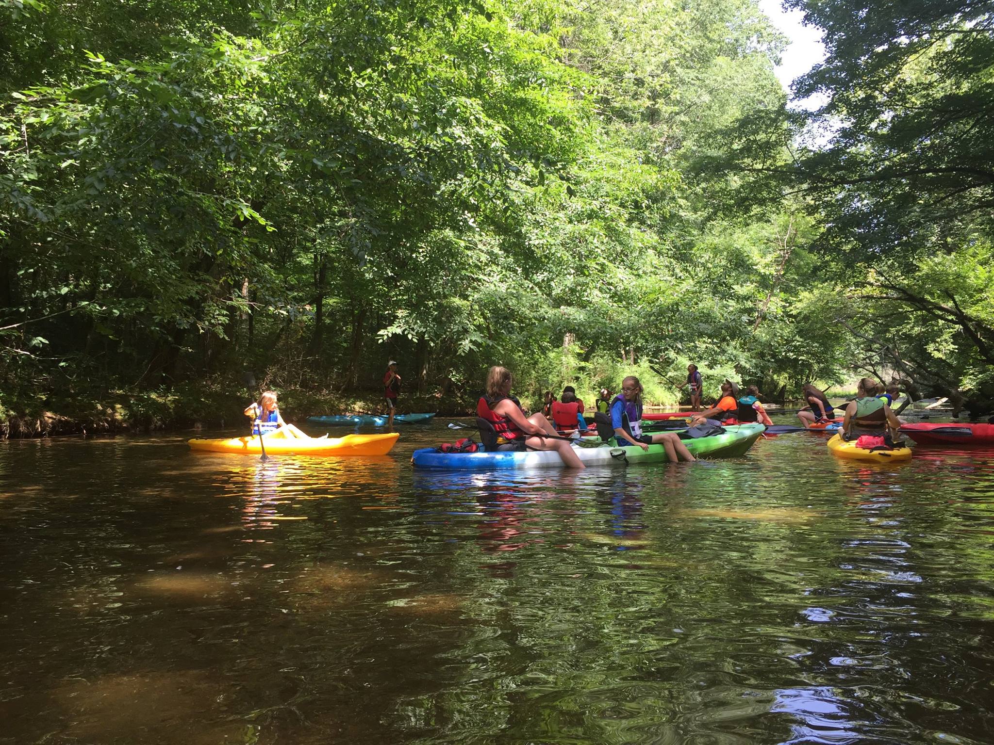 a group of people rowing a boat in the water